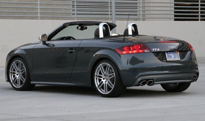 A three-quarter rear view of a 2009 meteor gray pearl Audi TTS Roadster