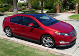A three-quarter front view of a red 2011 Chevrolet Volt