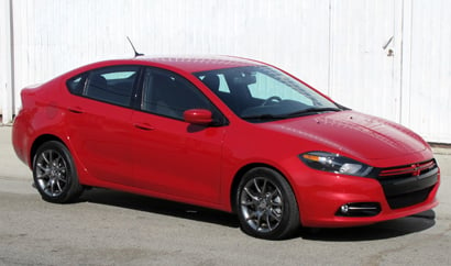 A three-quarter front view of a red 2013 Dodge Dart Rallye