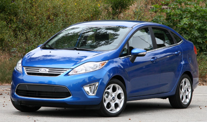 A three-quarter front view of a blue 2011 Ford Fiesta Sedan SEL