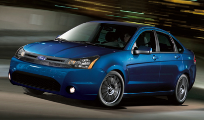 A three-quarter front view of a blue 2011 Ford Focus