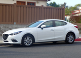 A side view of the 2013 Mazda 3 i 4-Door Touring A side view of the 2013 Mazda 3 i 4-Door Touring