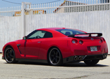 A three-quarter rear view of a red 2013 Nissan GT-R Black Edition A three-quarter rear view of a red 2013 Nissan GT-R Black Edition