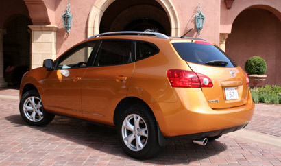 A three-quarter rear view of an orange 2008 Nissan Rogue SL 2WD