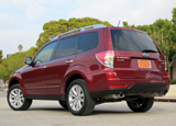 A three-quarter rear view of a red 2011 Subaru Forester 2.5X Touring A three-quarter rear view of a red 2011 Subaru Forester 2.5X Touring