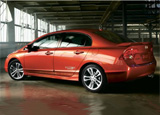 A three-quarter rear view of a red Honda Civic