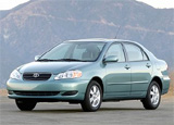 A three-quarter front view of a light-blue Toyota Corolla