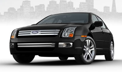 A three-quarter front view of a 2010 Sports Blue Ford Fusion