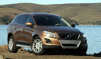 A three-quarter front view of a tan 2010 Volvo XC60