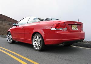 A three-quarter rear view of a red 2006 Volvo C70 T5
