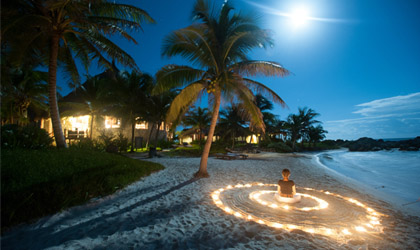 Guest practicing yoga on the beach at Maya Tulum in Mexico Guest practicing yoga on the beach at Maya Tulum in Mexico