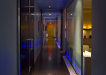 The modern spa features high ceilings, deep woods and frosted glass