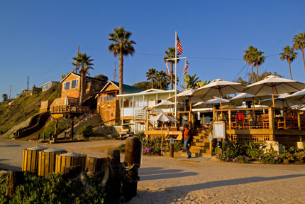 Watch the sunset while you dine on the beach at The Beachcomber at Crystal Cove 