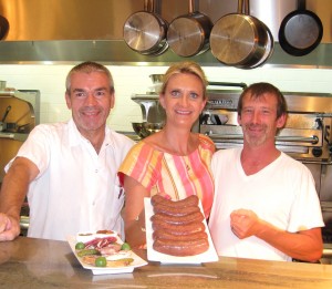 Chef Bruno Herve-Commereuc and his boudin noir (right), with chef de cuisine Hugues Quintard and Sophie Gayot