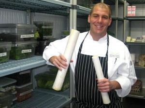 Chef Michael Fiorelli from mar'sel restaurant holding fresh hearts of palm