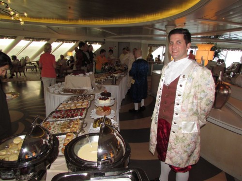 A server dressed in formal 18th-century garb during Mozart Tea