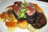 Ash-spiced venison loin with smoked polenta dumplings and dried cherry reduction