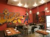 The dining room features a graffiti art mural