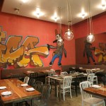 The dining room features a graffiti art mural