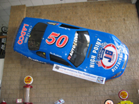 Racing vehicle displayed on a wall at the Justice Brothers museum