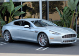 A three-quarter front view of a silver 2011 Aston Martin Rapide