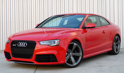 A three-quarter front view of a red 2013 Audi RS 5 Coupe
