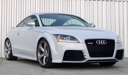 A three-quarter front view of a white 2012 Audi TT RS
