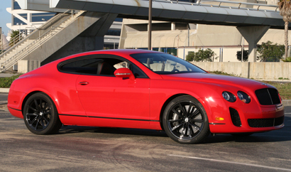 A three-quarter front view of a red 2010 Bentley Continental Supersports