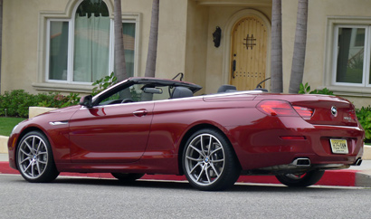 A three-quarter rear view of a red 2012 BMW 650i Convertible