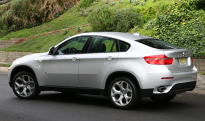 A three-quarter rear view of a silver 2008 BMW X6 xDrive35i