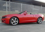 A side view of a red 2012 Chevrolet Camaro Convertible