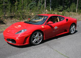 A three-quarter front view of a red 2006 Ferrari F430 Coupe