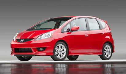 A three-quarter front view of a red 2009 Honda Fit Sport