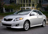 A three-quarter front view of a silver Toyota Corolla