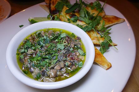 Chef Bryant Ng presents dishes such as chopped escargot with tandoor-blistered naan at Cassia