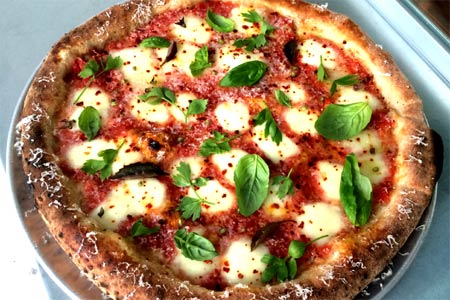 At Bruno, the margherita pizza comes with fermented tomatoes and is sprinkled with herbs
