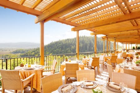 Sip wine and watch the sunset on Auberge du Soleil's romantic deck overlooking Napa Valley.