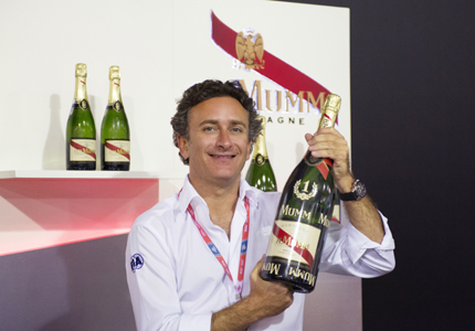 Formula E CEO Alejandro Agag holds a bottle of G. H. Mumm Champagne to celebrate the new partnership
