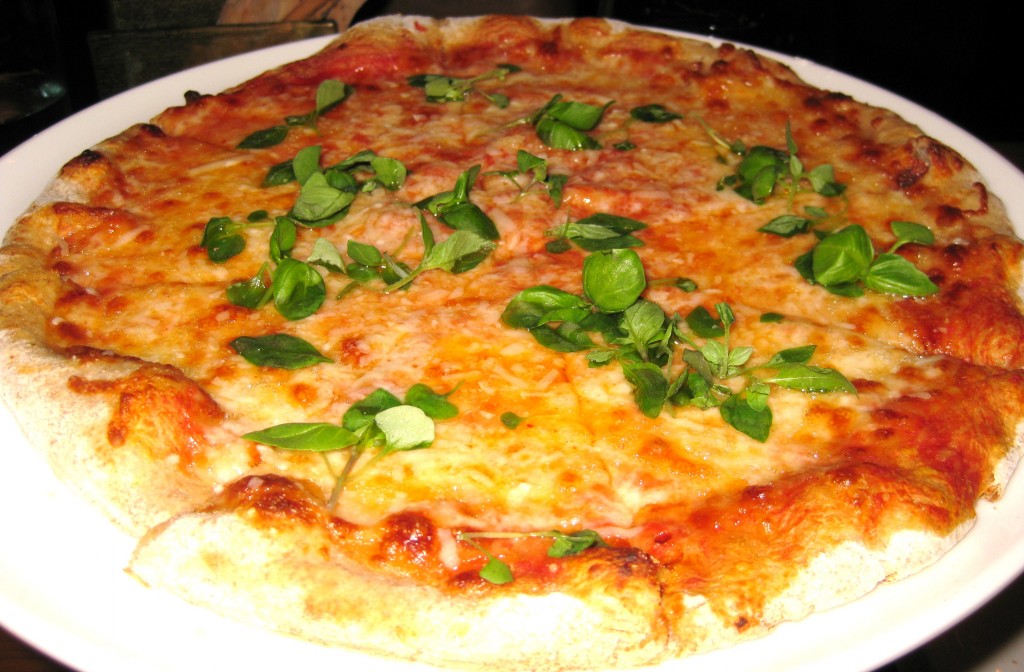Margherita pizza with buffalo mozzarella, basil & tomato sauce on a wheat crust