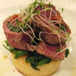 Il Moro: Pan roasted filet of lamb rolled with spinach, baked tomatoes & olives with a potato cake & rapini