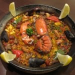 Mix Paella with lobster, chicken, chorizo, vegetables and saffron rice