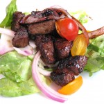 Shaken beef with carmelized red onions and over butter lettuce