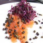 Cured salmon carpaccio with fried capers, horseradish crème fraiche and garden herbs