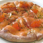 House smoked salmon pizza with shaved sweet onions, dill cream sauce, and salmon pearls