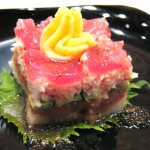 Sushi cake; cake formation with layers of crab, spicy tuna, tuna, rice, mashed potato with caviar