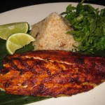 Pescado Zarandeado: wood-grilled striped bass basted with red chili, served with Veracruz-style white rice with sweet plantains and arugula salad