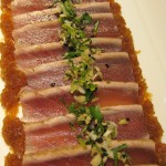 Thinly-sliced fresh seared tuna with soy and ginger vinaigrette dressing