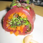 Raw tuna rolled and stuffed with marinated vegetables and preserved truffles