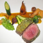 Caper-crusted lamb loin with Weiser carrots, fava beans, pearl onions and mint-infused lamb jus