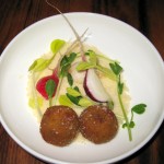 Sweet petit pois arancini on a bed of pea shoots and Coleman farm radishes